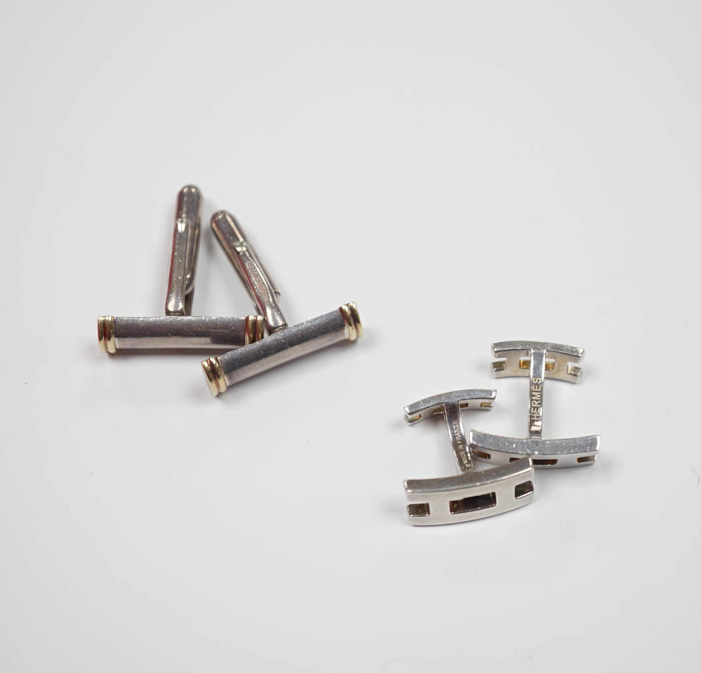 A pair of Tiffany & Co, 925 and 18k baton shaped cufflinks, 22mm and a modern pair of Hermes silver cufflinks.